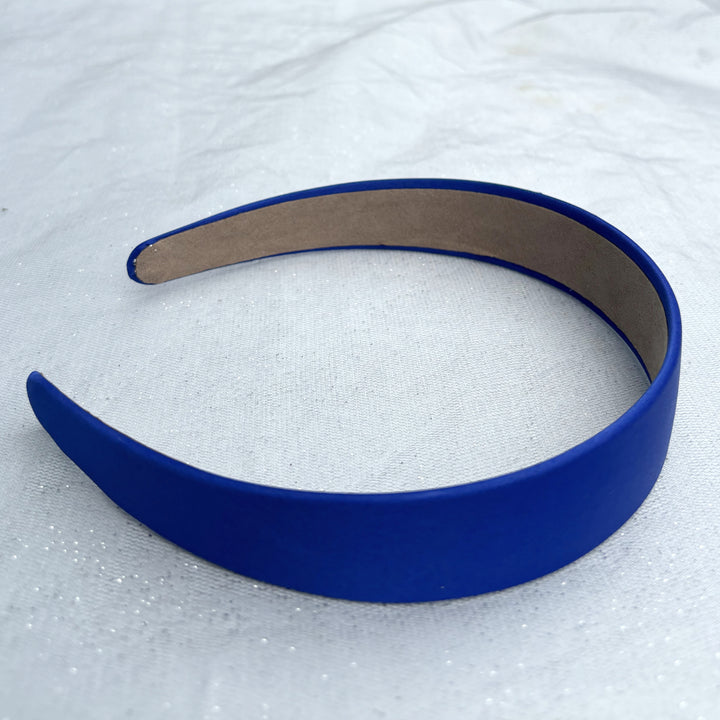 Royal blue hairband, smooth satin finish, bold deep blue shade, padded structure, sleek minimalist design, versatile fashion accessory