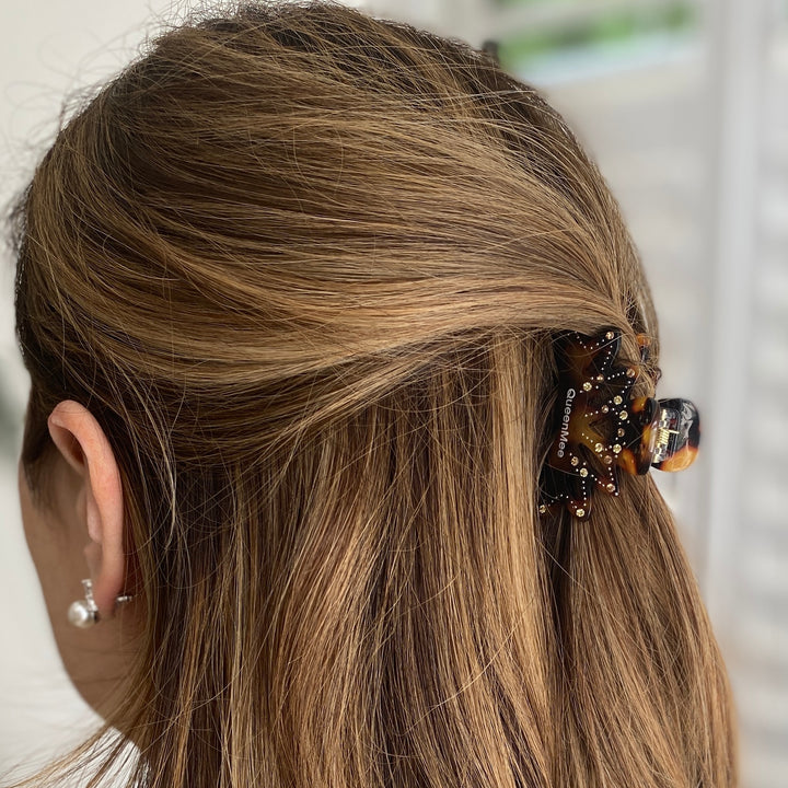 Small tortoiseshell hair claw, gold metal base, crystal jewel embellishments, strong grip design, elegant decorative hair accessory