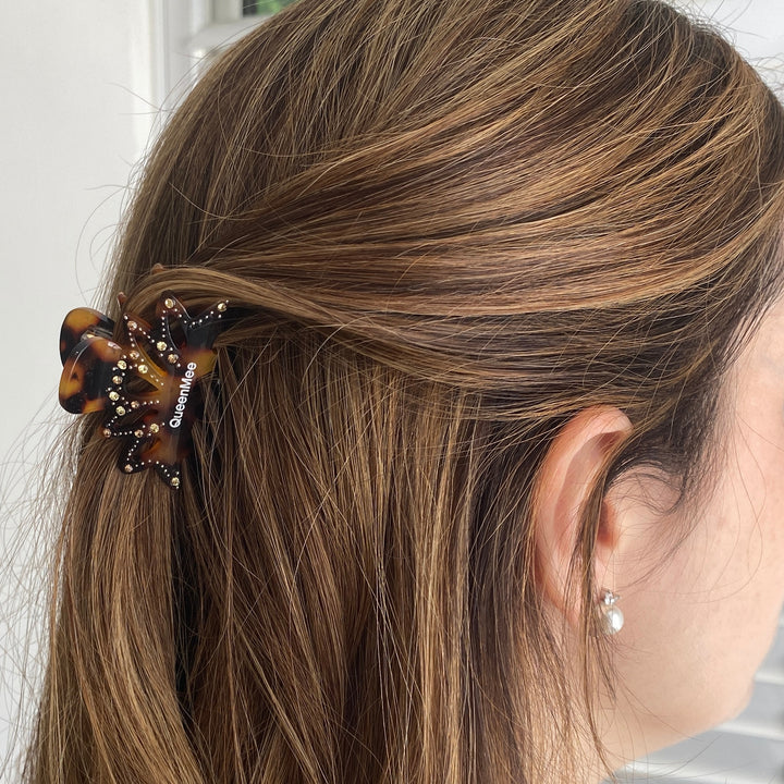 Small tortoiseshell hair claw, crystal jewel embellishments, gold metal base, strong grip design, elegant decorative hair accessory