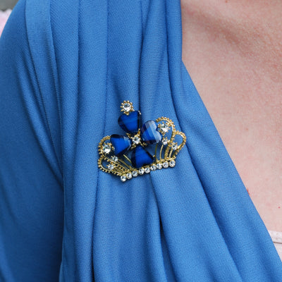 blue brooch with rhinestone worn