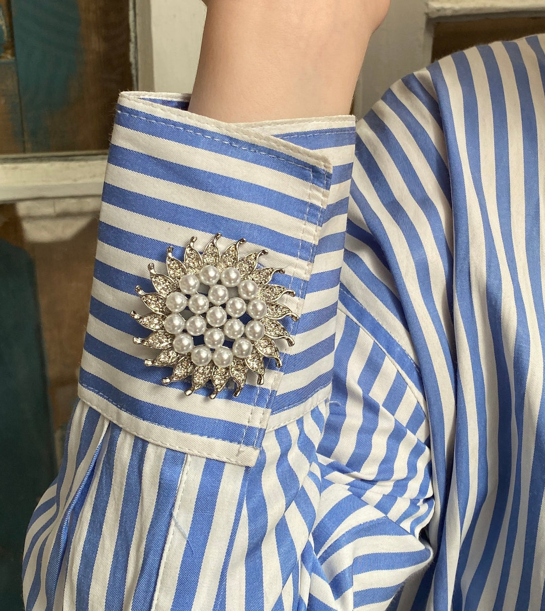 silver sunflower brooch with pearls on cuff