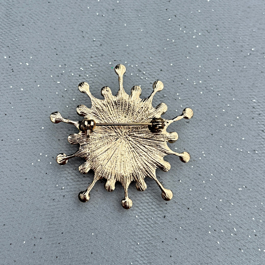 Gold starburst brooch, textured metal finish, radiating sunburst design, secure pin fastening, vintage inspired jewellery, bold statement accessory, elegant gift for her
