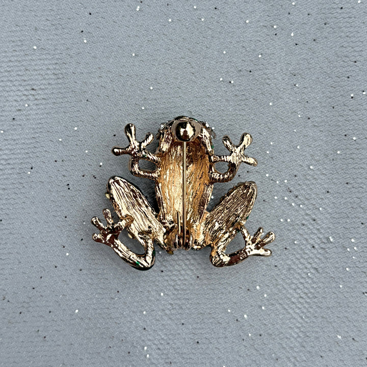 Frog brooch, gold tone metal, green enamel body, clear crystal diamante accents, playful animal design, vintage inspired jewellery, sparkling statement accessory, unique gift for her
