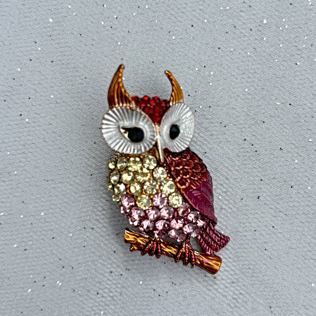 Owl brooch, gold tone metal, encrusted with pink, yellow and red crystals, large white enamel eyes with black detail, perched on branch design, sparkling statement jewellery, vintage inspired animal accessory, unique gift for her

