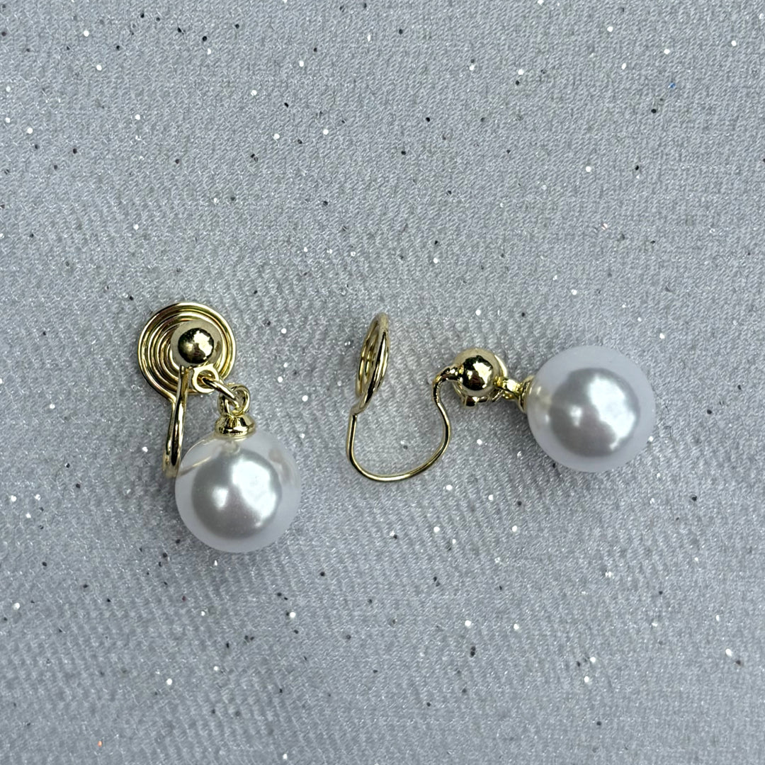 Pearl drop clip-on earrings, gold tone setting, round white faux pearls, secure hinged clip fastening, classic timeless design, vintage inspired jewellery, elegant non-pierced earrings, sophisticated accessory or gift for her
