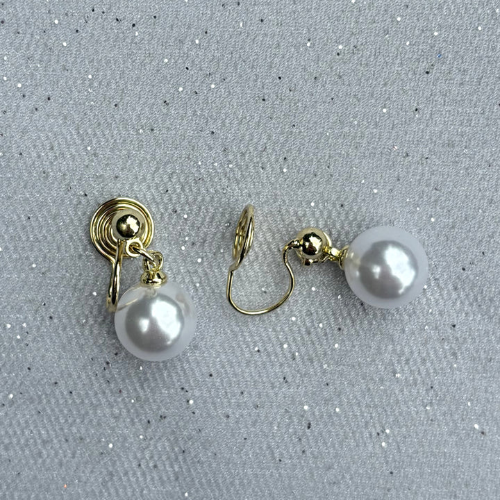 Pearl drop clip-on earrings, gold tone setting, round white faux pearls, secure hinged clip fastening, classic timeless design, vintage inspired jewellery, elegant non-pierced earrings, sophisticated accessory or gift for her
