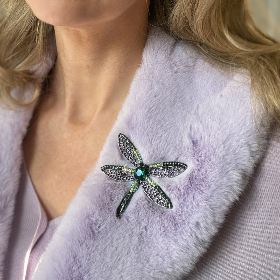 Green crystal dragonfly brooch with lace-style wings and an emerald centre stone.