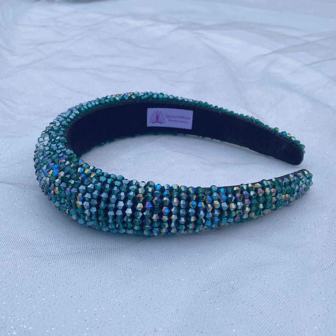 Emerald green beaded headband covered in sparkling crystals on a padded band.