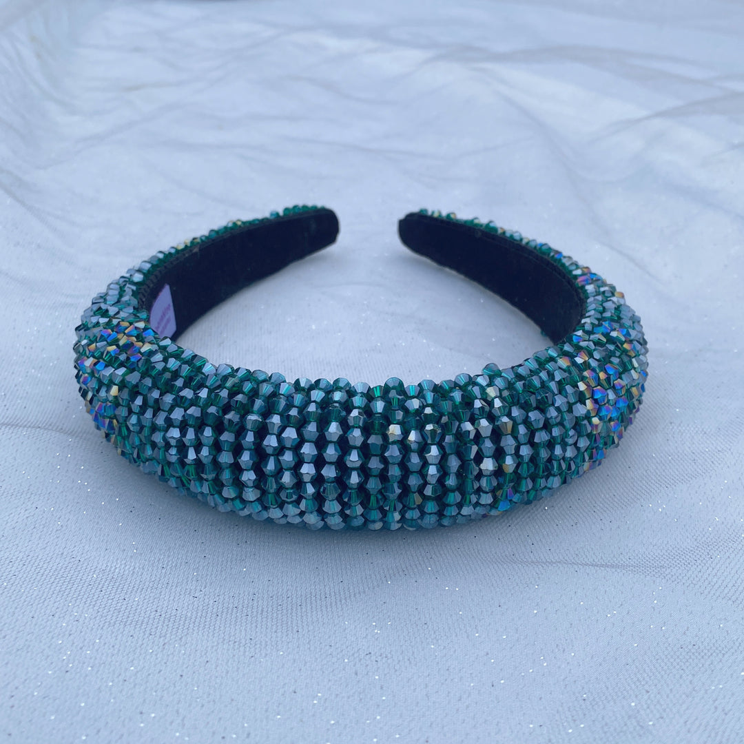 Emerald green beaded headband covered in sparkling crystals on a padded band.