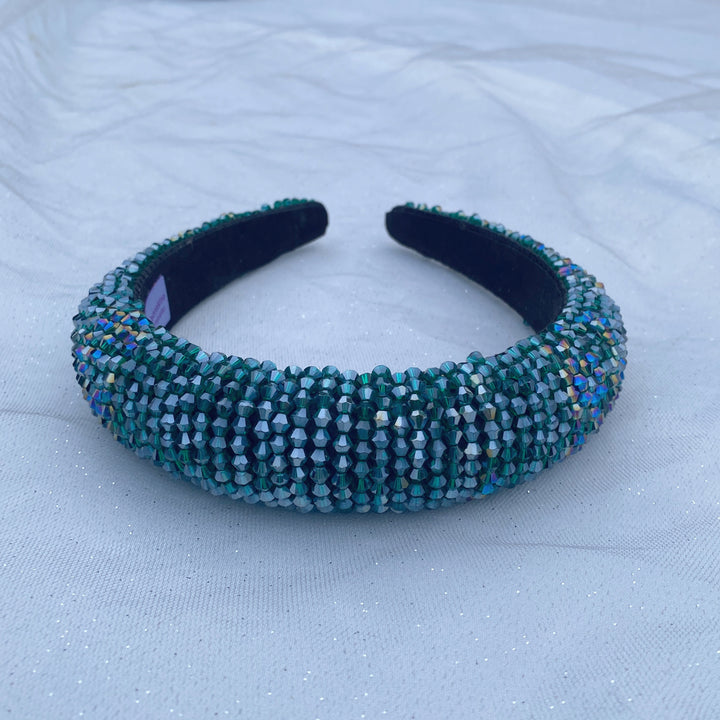 Emerald green beaded headband covered in sparkling crystals on a padded band.