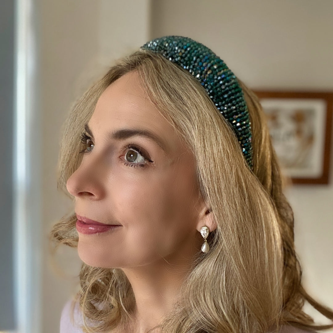 Emerald green beaded headband covered in sparkling crystals on a padded band.