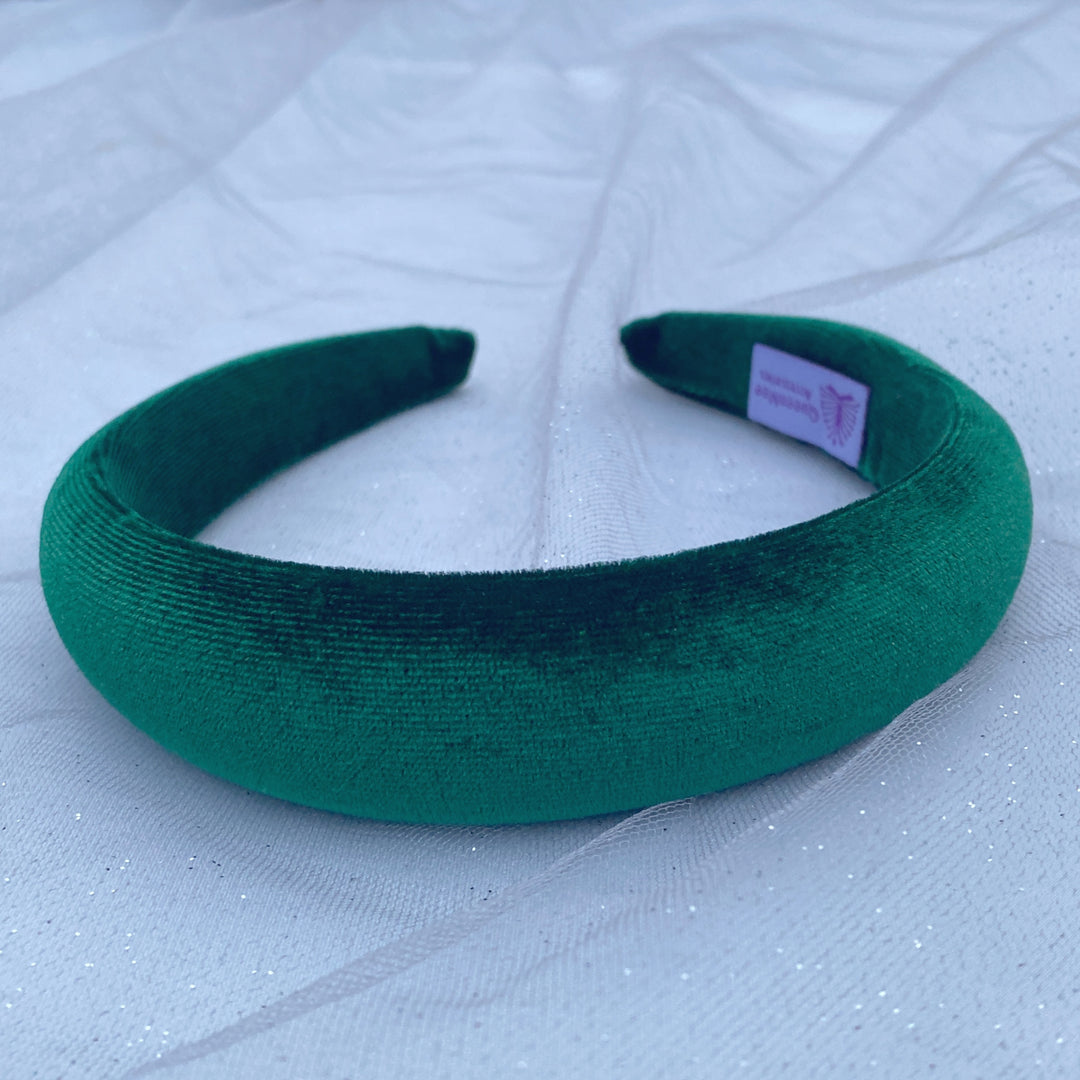 Green velvet hairband with a soft padded design.
