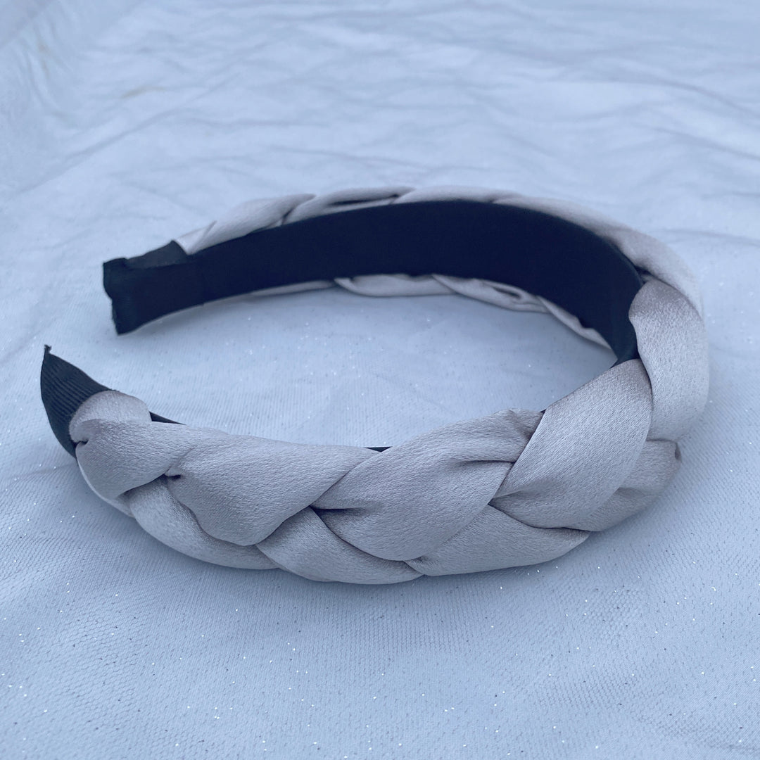 Light grey satin braided headband with a soft, padded structure.