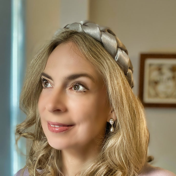 Light grey satin braided headband with a soft, padded structure.