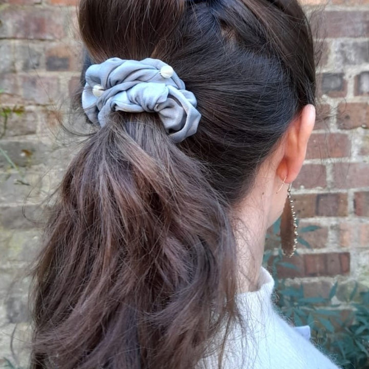 grey pearl scrunchie worn in a ponytail