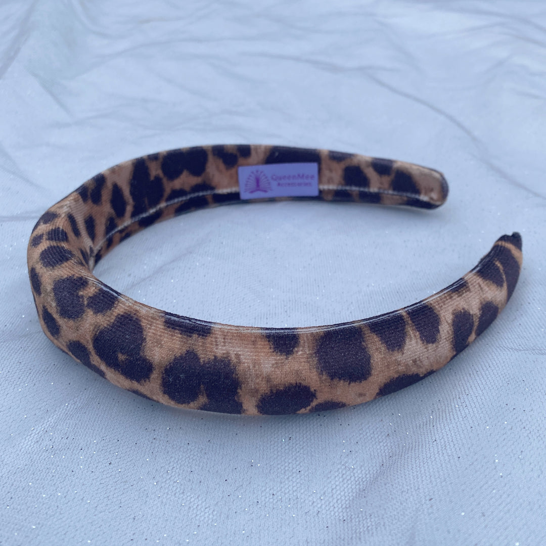 Padded leopard print headband with soft fabric in brown and black tones.