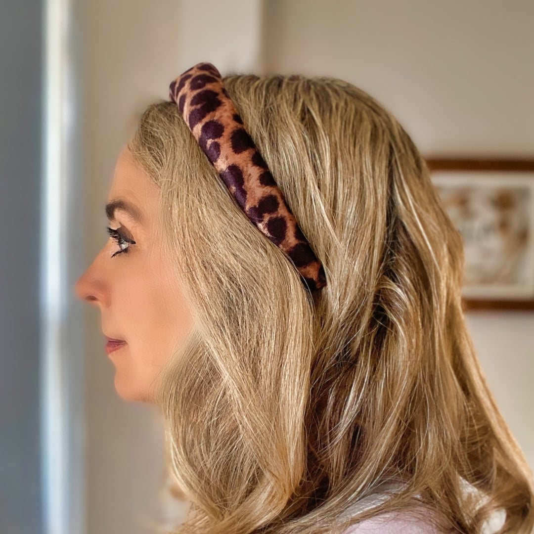 Padded leopard print headband with soft fabric in brown and black tones.