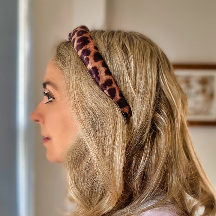 Padded leopard print headband with soft fabric in brown and black tones.