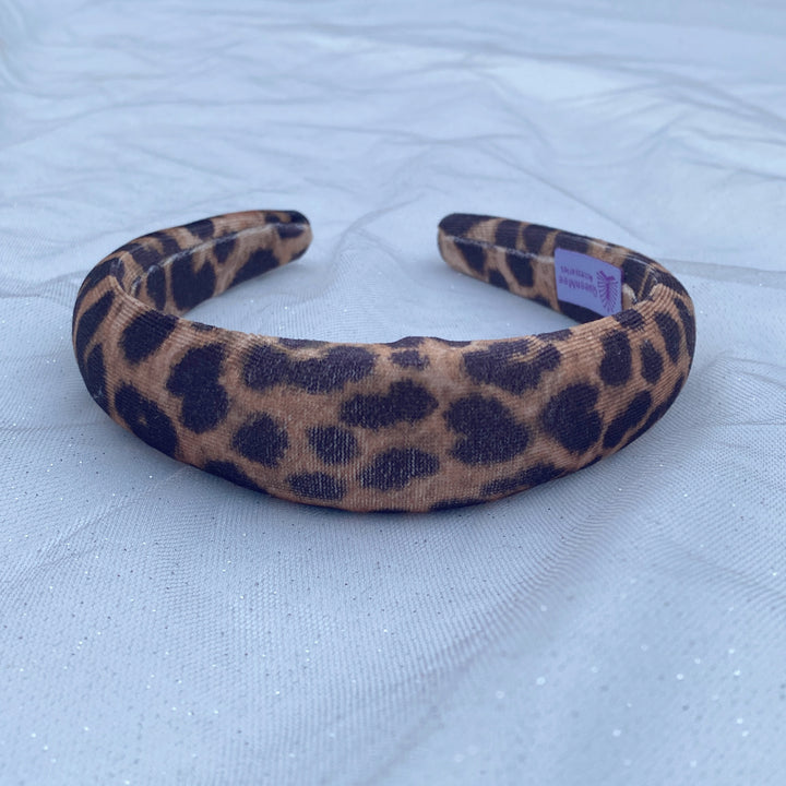 Padded leopard print headband with soft fabric in brown and black tones.