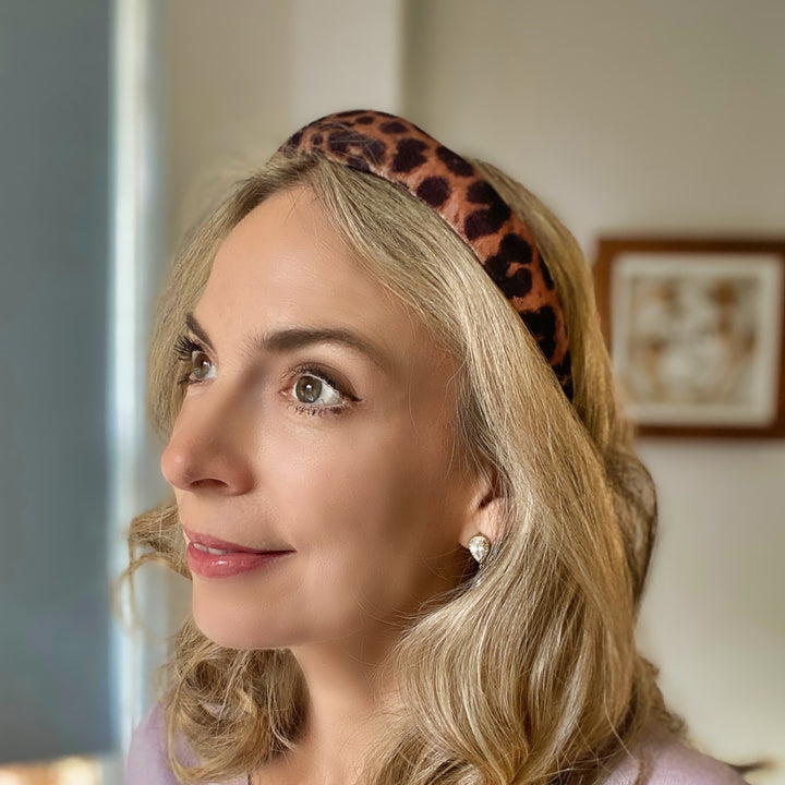 Padded leopard print headband with soft fabric in brown and black tones.