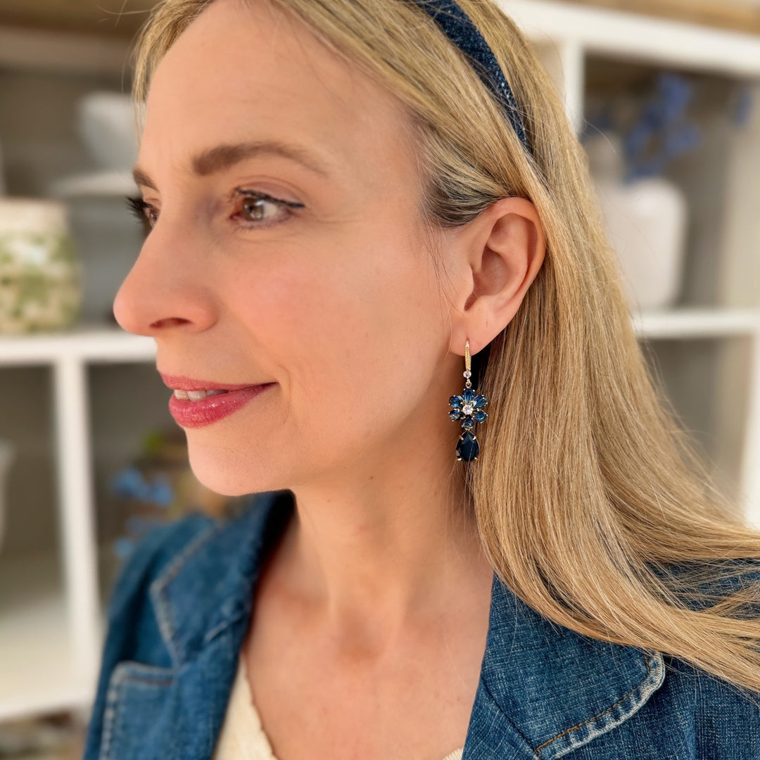 navy blue earrings flower drop earrings worn by a woman with a headband and denim jacket a daytime outfit