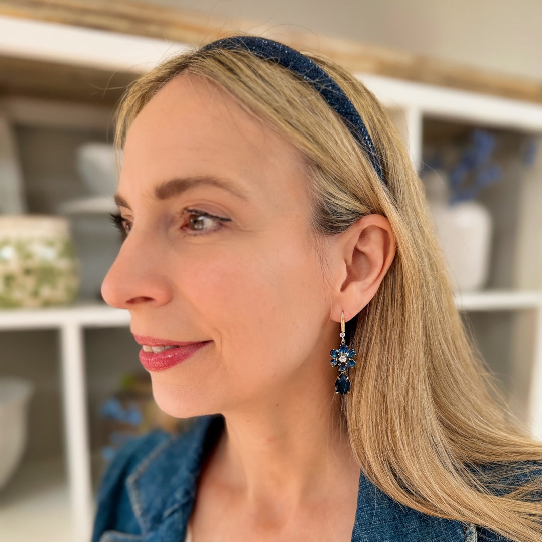 navy blue headband and earrings set with sparkles worn with a denim jacket to accessorize a daytime outfit