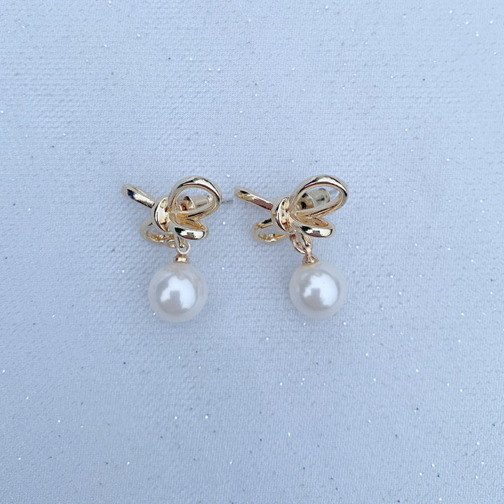 pearl drop earrings with gold bow