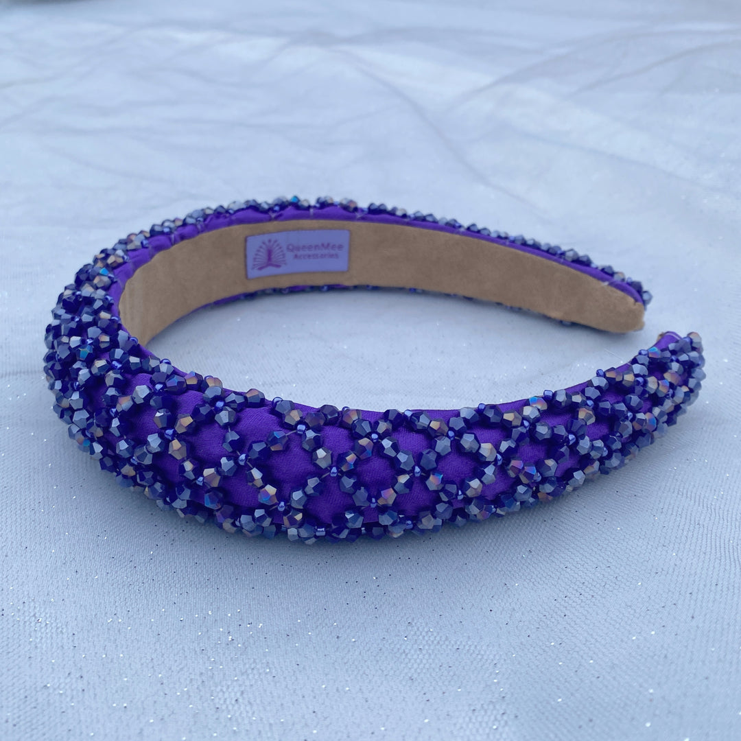 Purple padded headband embellished with clustered crystals for a sparkly textured finish.