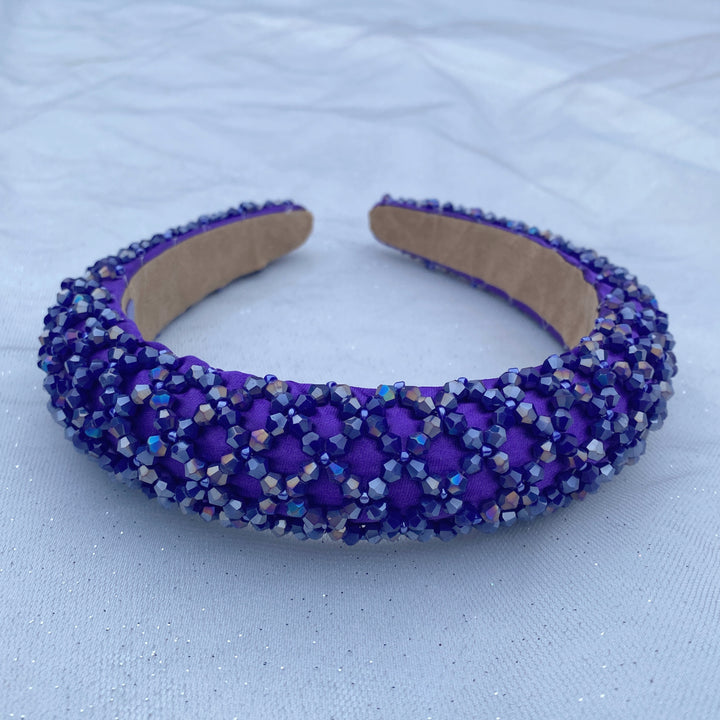 Purple padded headband embellished with clustered crystals for a sparkly textured finish.