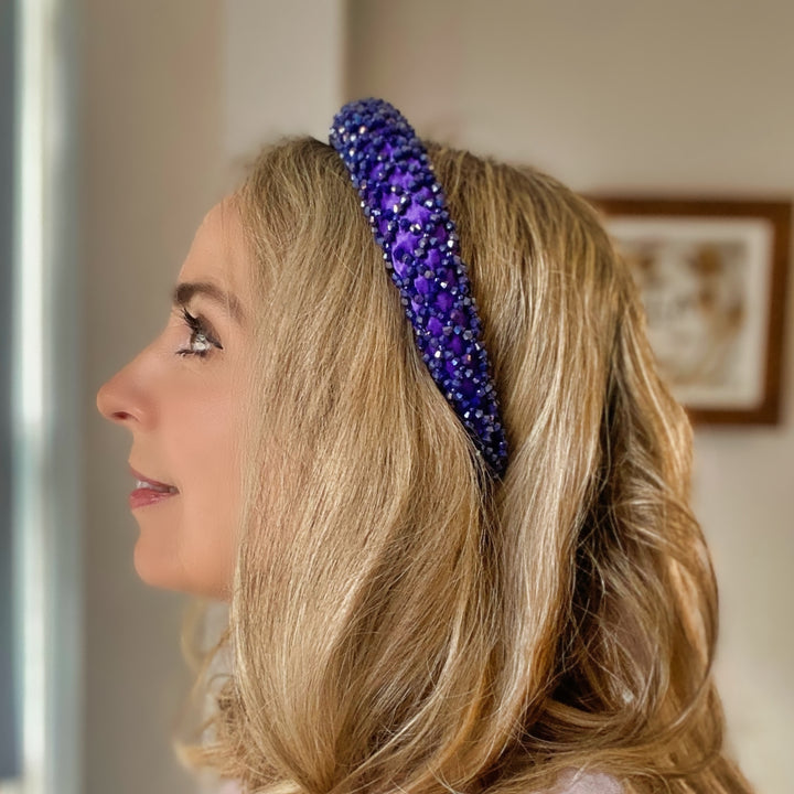 Purple padded headband embellished with clustered crystals for a sparkly textured finish.