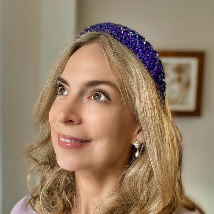 Purple padded headband embellished with clustered crystals for a sparkly textured finish.