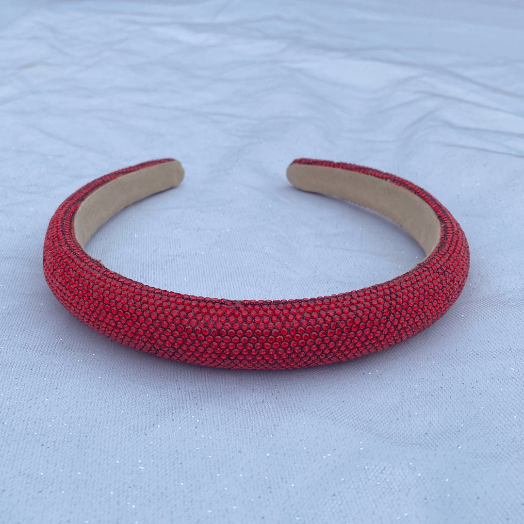 Red sparkly padded headband covered in tiny shimmering crystals.