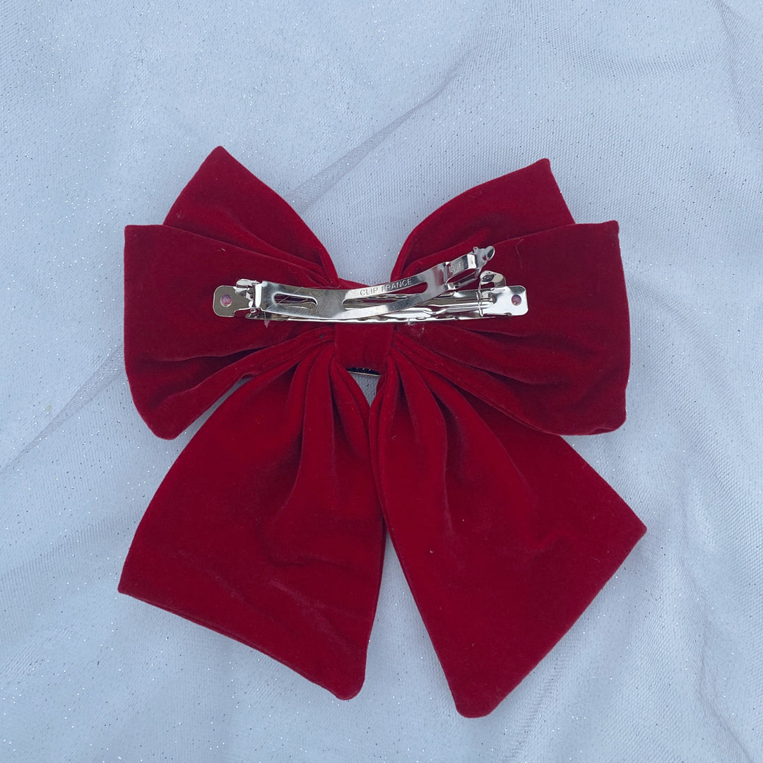 Large red velvet bow hair clip with a jeweled buckle detail.