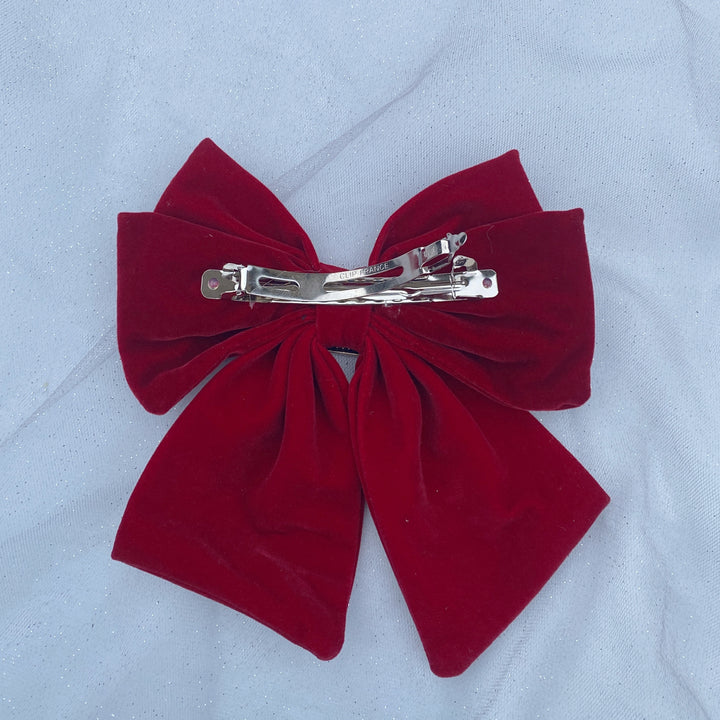 Large red velvet bow hair clip with a jeweled buckle detail.