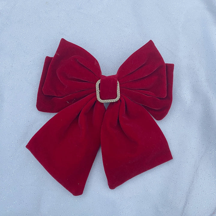 Large red velvet bow hair clip with a jeweled buckle detail.
