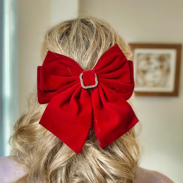 Large red velvet bow hair clip with a jeweled buckle detail.