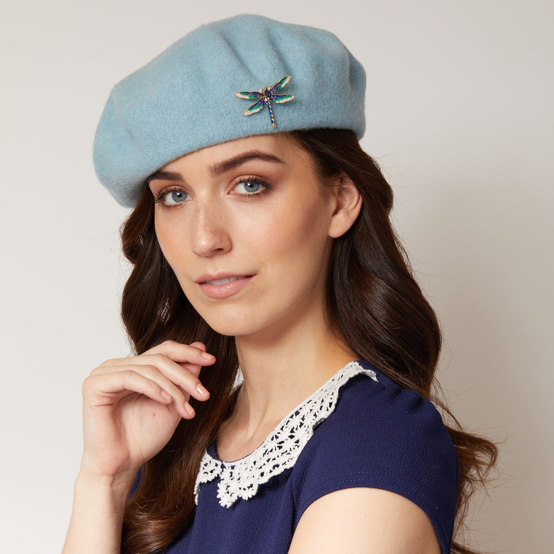 beret with brooch in blue styled