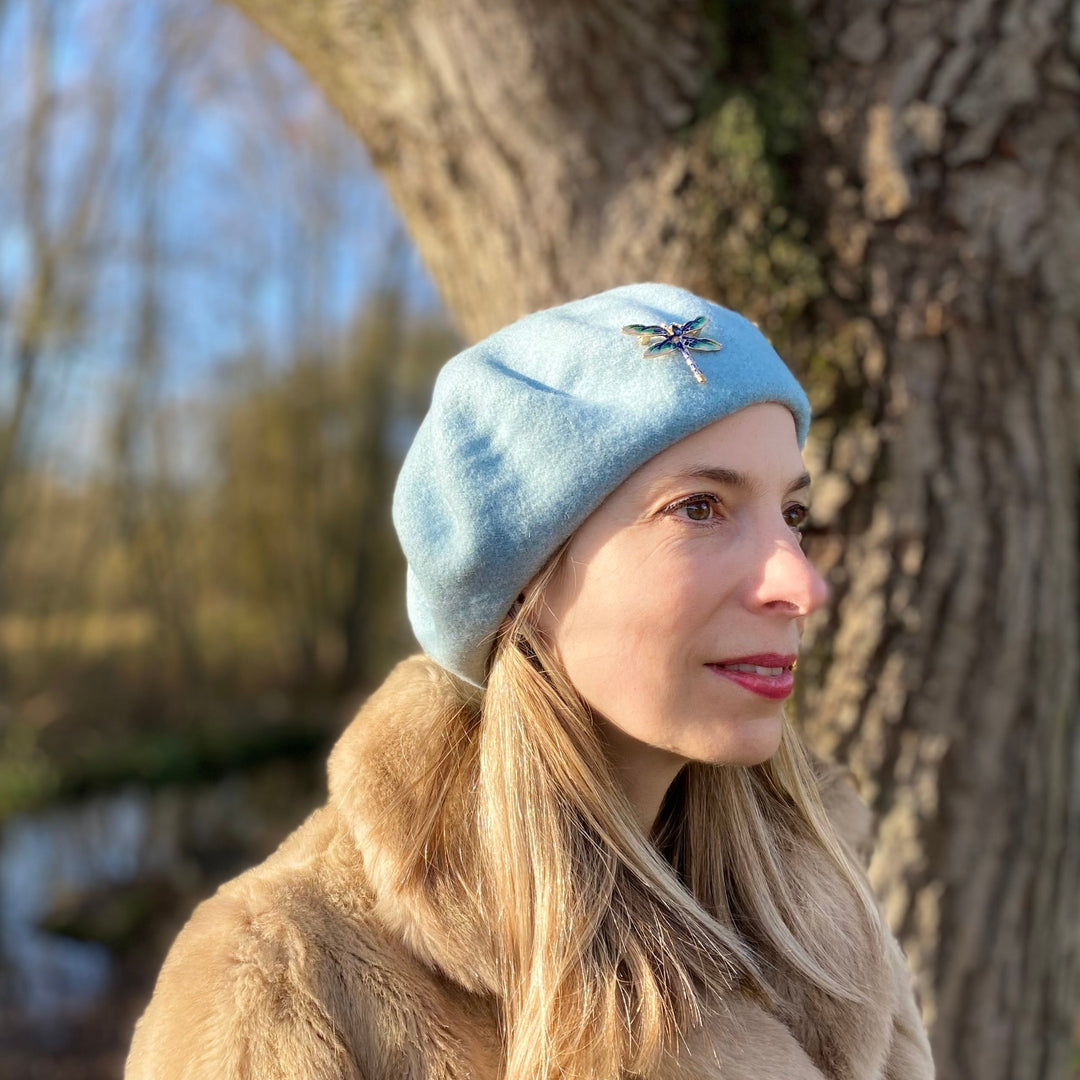 blue beret with dragonfly brooch for wedding guest