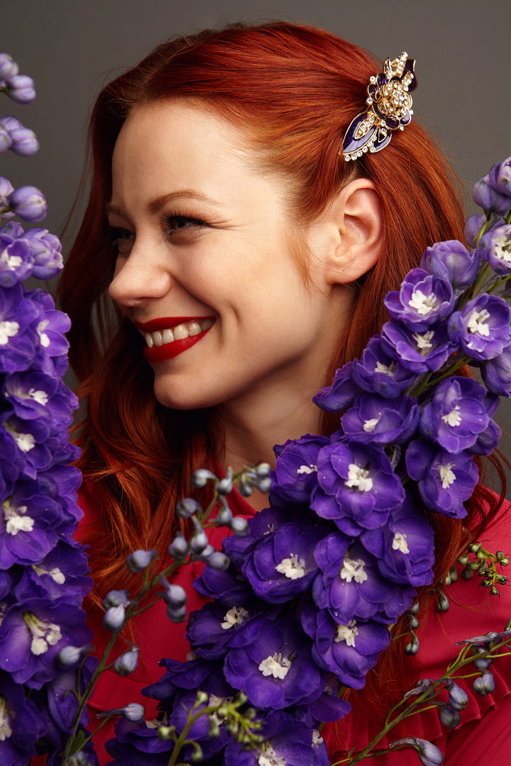 flower hair clip in purple wedding guest hair