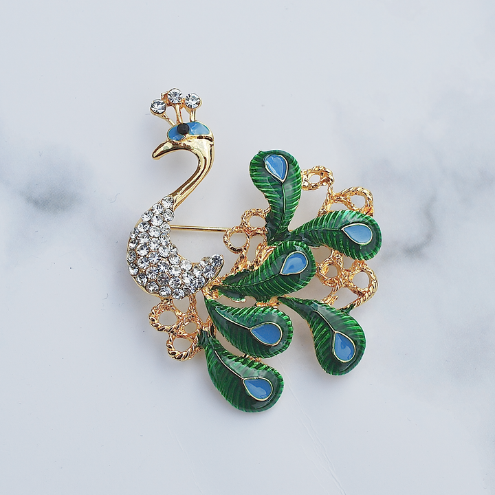 peacock brooch blue green and gold