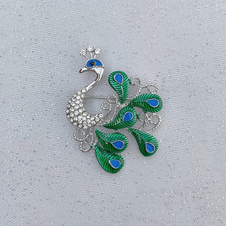 peacock brooch in silver with blue and green