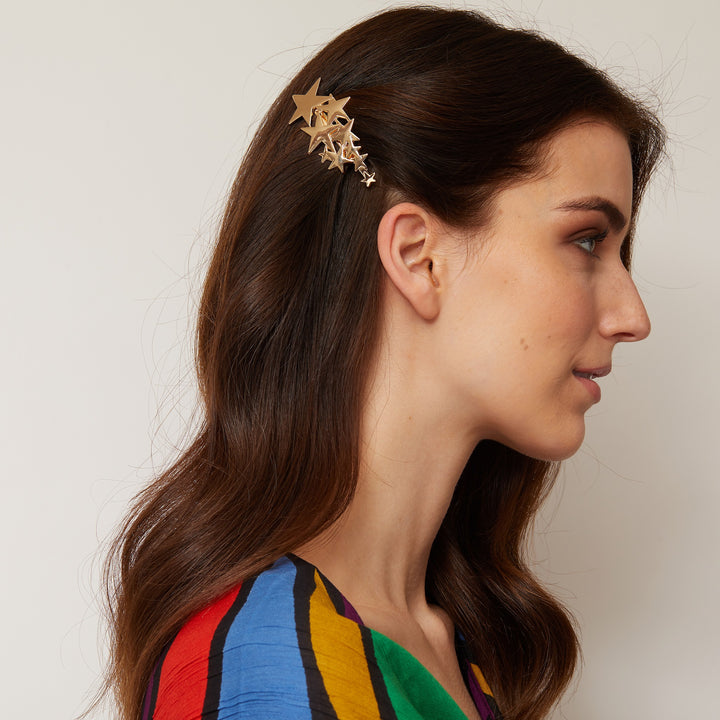 star hair clip in gold styled for festival hair