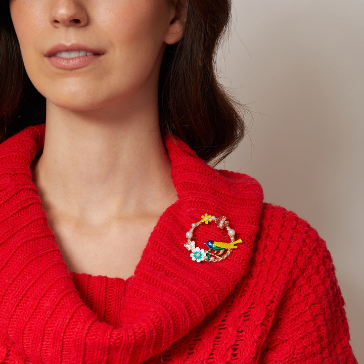vintage brooch with bird in enamel worn on red jumper
